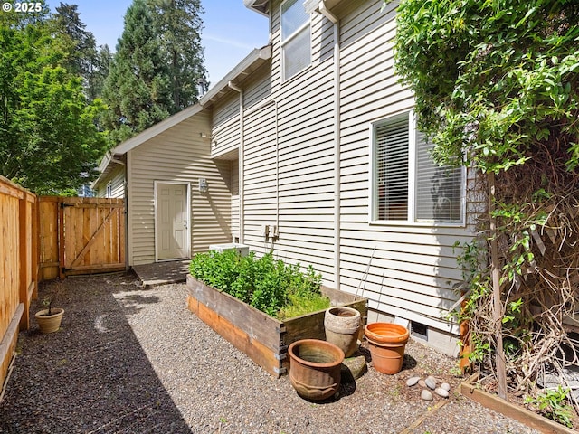 17712 SW 81st Pl, Durham, OR 97224 - view of side of home with crawl space, fence, a gate, and a garden