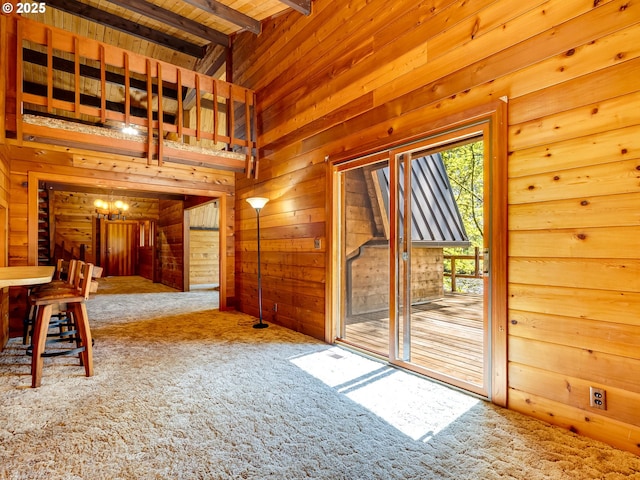 26619 NE 77th Ave, Battle Ground, WA 98604 - unfurnished living room featuring carpet floors, wooden walls, and a notable chandelier