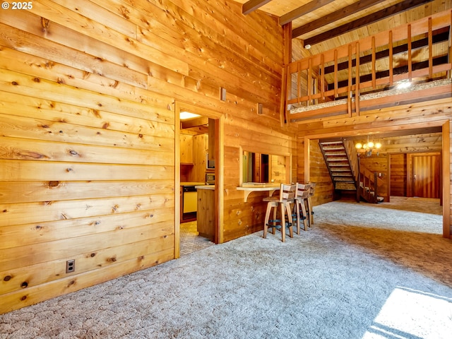 26619 NE 77th Ave, Battle Ground, WA 98604 - living room with wooden walls, beamed ceiling, carpet flooring, and stairs