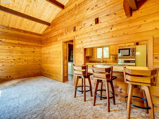 26619 NE 77th Ave, Battle Ground, WA 98604 - kitchen featuring wood walls, light carpet, wood ceiling, built in microwave, and lofted ceiling with beams