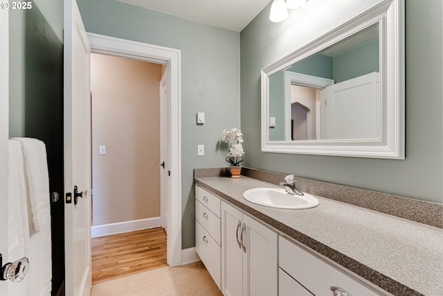 1556 Washington St, Eugene, OR 97401 - bathroom with vanity, baseboards, and wood finished floors