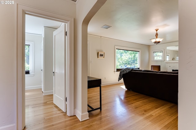 1556 Washington St, Eugene, OR 97401 - hallway featuring light wood-style flooring, plenty of natural light, baseboards, and a chandelier