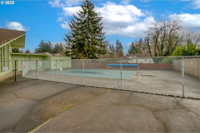 view of pool with tennis court