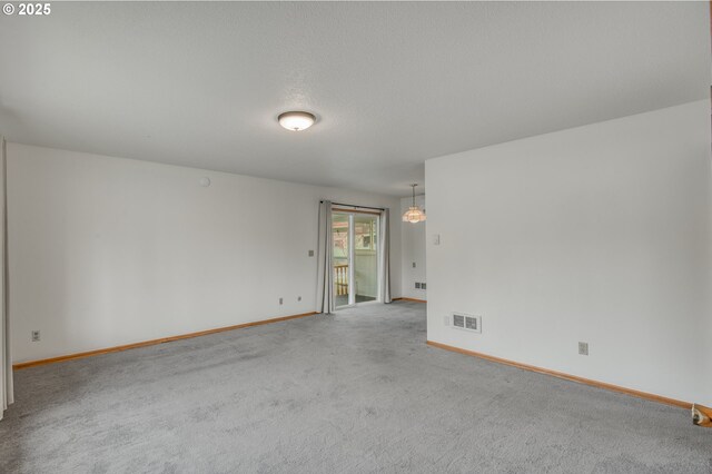 interior space featuring dark colored carpet, white fridge, and hanging light fixtures