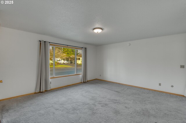 kitchen featuring light carpet, white electric range oven, and a textured ceiling