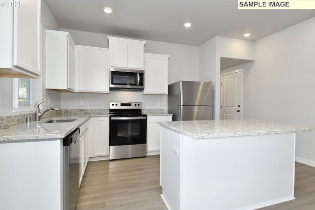 5329 NE 68th St, Vancouver, WA 98661 - kitchen with stainless steel appliances, white cabinets, a sink, and a kitchen island