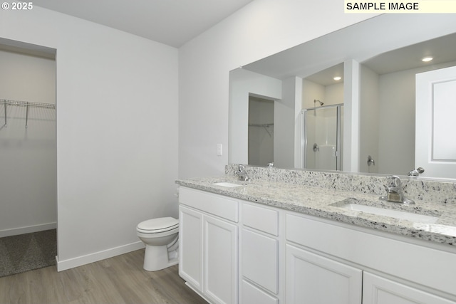 5329 NE 68th St, Vancouver, WA 98661 - full bathroom with toilet, wood finished floors, a sink, a walk in closet, and a stall shower
