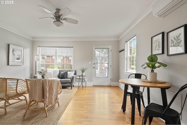 2643 NW Raleigh St Unit 30, Portland, OR 97210 - dining area featuring a wall mounted air conditioner, crown molding, light wood-type flooring, ceiling fan, and baseboards