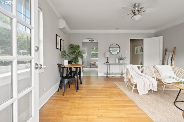 2643 NW Raleigh St Unit 30, Portland, OR 97210 - foyer featuring a wall mounted air conditioner, arched walkways, a ceiling fan, light wood-style flooring, and ornamental molding