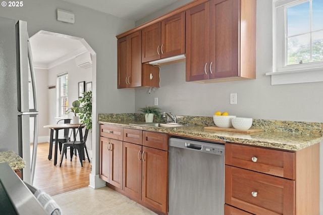 2643 NW Raleigh St Unit 30, Portland, OR 97210 - kitchen featuring stainless steel dishwasher, a sink, freestanding refrigerator, plenty of natural light, and ornamental molding