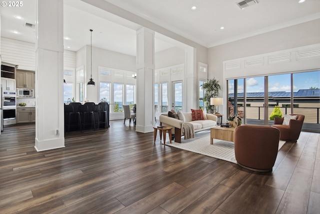 5360 NW 18th Ave, Camas, WA 98607 - living room with a high ceiling, decorative columns, dark wood-type flooring, crown molding, and recessed lighting
