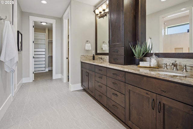 5360 NW 18th Ave, Camas, WA 98607 - bathroom with double vanity, a walk in closet, recessed lighting, and baseboards