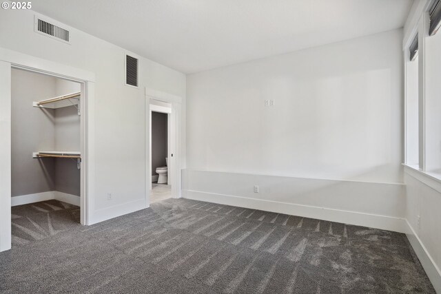 5360 NW 18th Ave, Camas, WA 98607 - unfurnished bedroom featuring dark colored carpet, baseboards, a spacious closet, and a closet