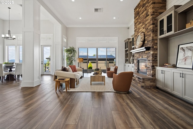 5360 NW 18th Ave, Camas, WA 98607 - living area featuring a chandelier, dark wood finished floors, a high ceiling, a stone fireplace, and recessed lighting