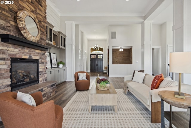 5360 NW 18th Ave, Camas, WA 98607 - living room featuring wood finished floors, a stone fireplace, crown molding, and baseboards