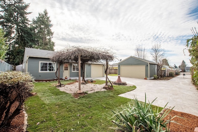 single story home featuring a front lawn, an outdoor structure, fence, and a detached garage