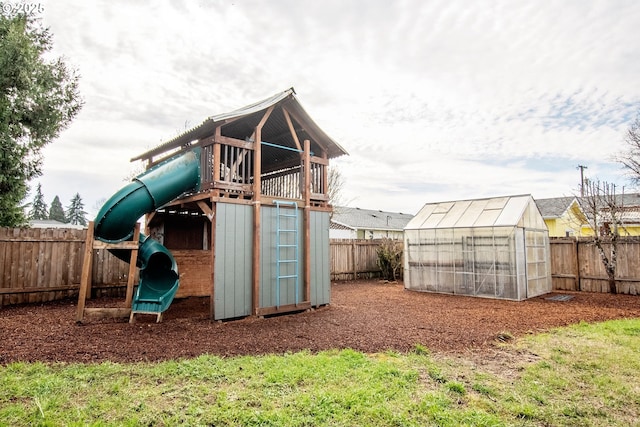 view of jungle gym featuring a fenced backyard, an exterior structure, and an outdoor structure