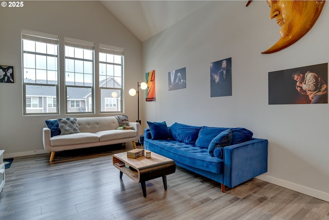 living room with hardwood / wood-style flooring and high vaulted ceiling