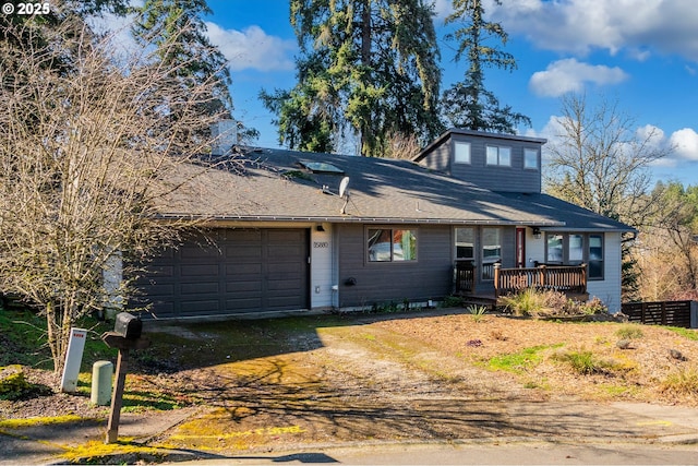 view of front facade featuring a deck, an attached garage, fence, driveway, and a chimney