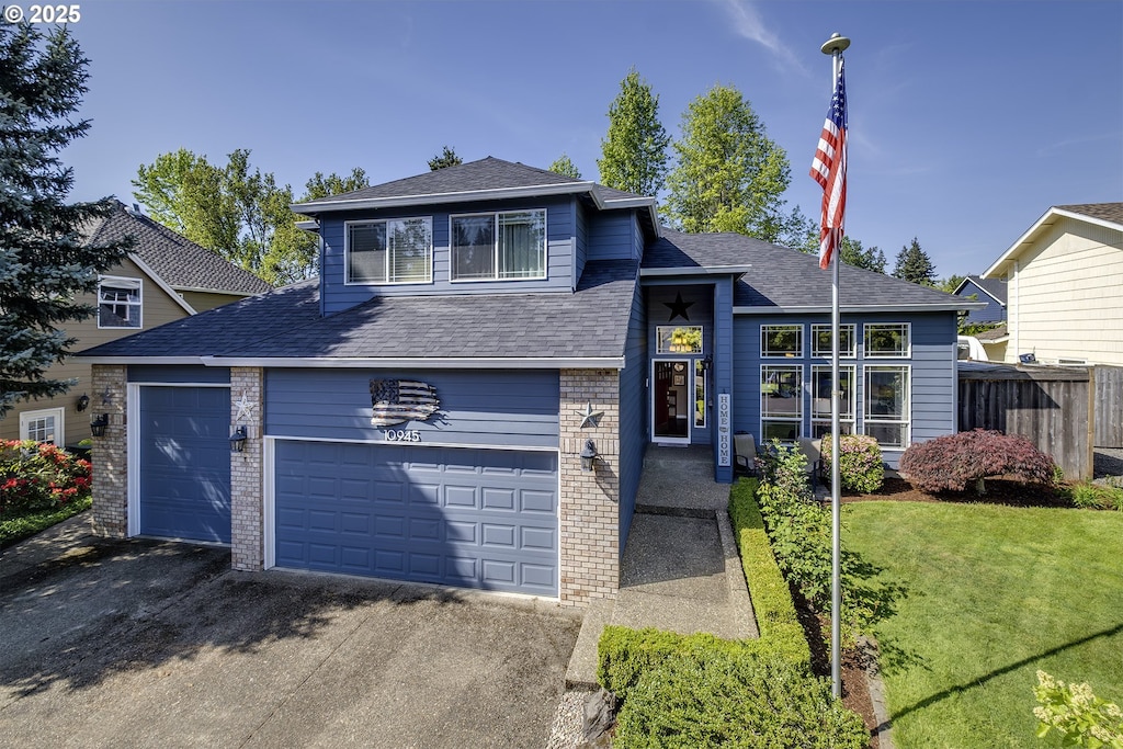 10945 SW Tunica St, Tualatin, OR 97062 - tri-level home featuring brick siding, roof with shingles, and driveway