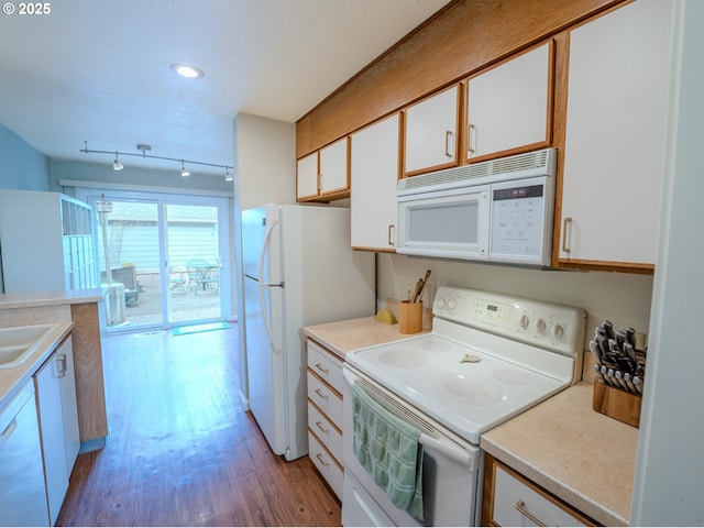 kitchen with white appliances, light wood-style floors, white cabinets, and light countertops