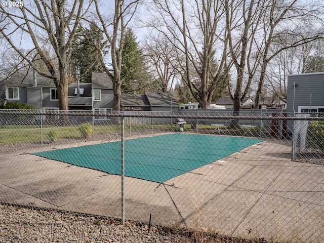 community pool featuring a patio and fence