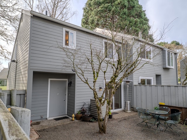 rear view of house with fence