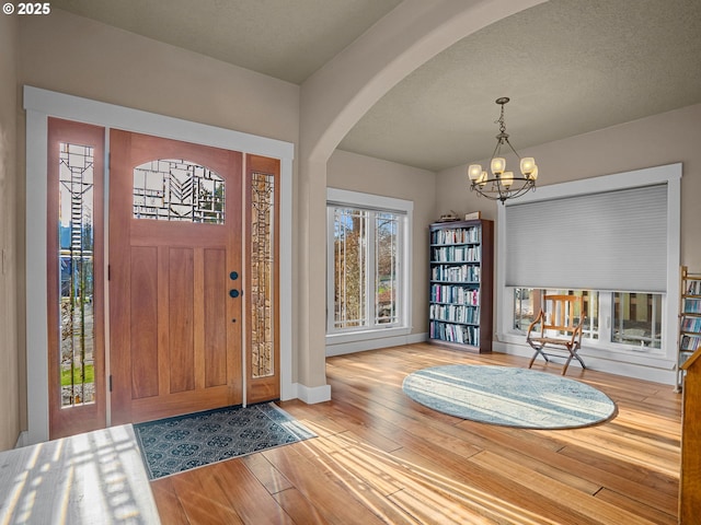 foyer entrance featuring a chandelier and light hardwood / wood-style floors