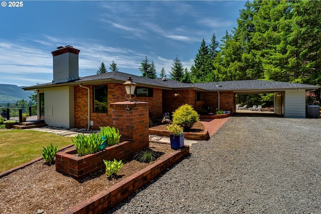 36555 Mcgowan Creek Rd, Springfield, OR 97478 - ranch-style home featuring a chimney, brick siding, gravel driveway, and a carport