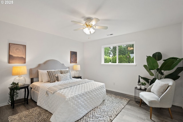 bedroom with baseboards, wood finished floors, and ceiling fan