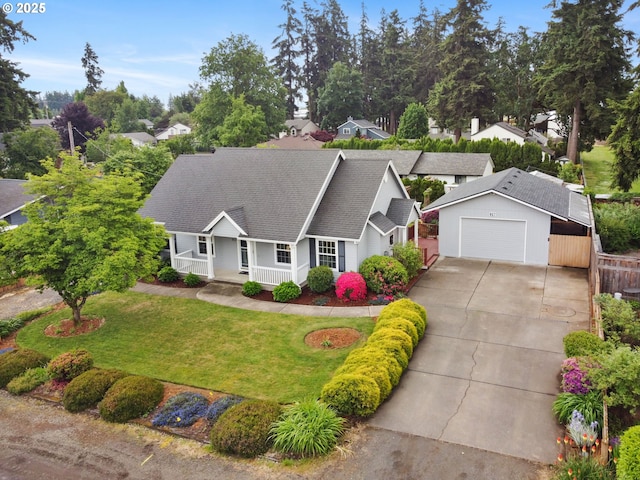 view of front facade featuring covered porch, driveway, and a garage