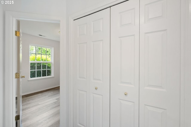 hallway with wood finished floors and baseboards