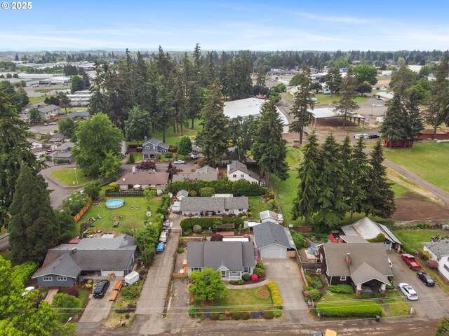 aerial view of property and surrounding area featuring nearby suburban area