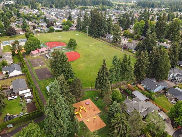 aerial view of property and surrounding area featuring nearby suburban area