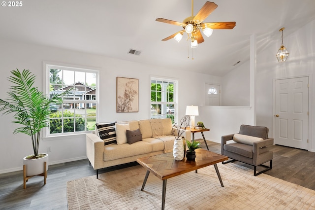 living area featuring vaulted ceiling, wood finished floors, baseboards, and ceiling fan
