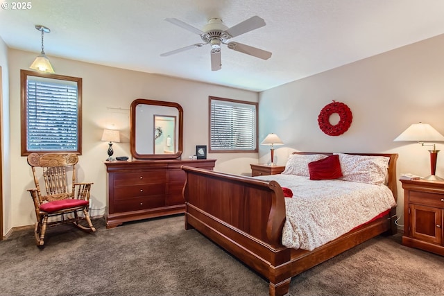 bedroom featuring dark colored carpet and ceiling fan