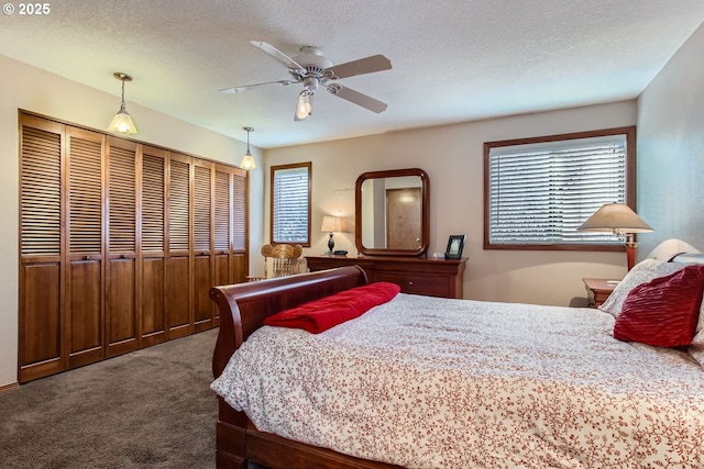 bedroom featuring carpet flooring, ceiling fan, a textured ceiling, and a closet