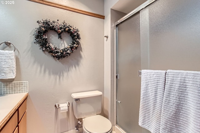 bathroom with vanity, an enclosed shower, and toilet