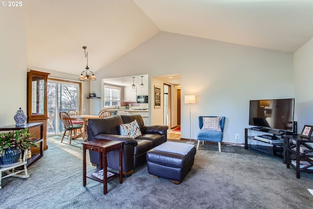 living room with a chandelier, carpet, and high vaulted ceiling