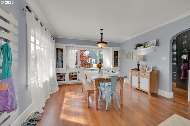 683 Laurel, Junction City, OR 97448 - dining area featuring arched walkways, light wood-type flooring, crown molding, and baseboards