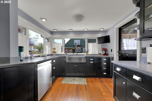 683 Laurel, Junction City, OR 97448 - kitchen featuring dishwasher, dark cabinets, a sink, and plenty of natural light