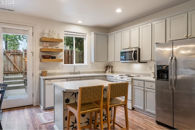 5862 SE Woodland Dr, Gresham, OR 97080 - kitchen featuring a sink, visible vents, a healthy amount of sunlight, and stainless steel appliances