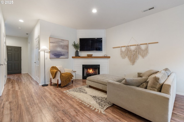5862 SE Woodland Dr, Gresham, OR 97080 - living area with a large fireplace, visible vents, recessed lighting, and wood finished floors
