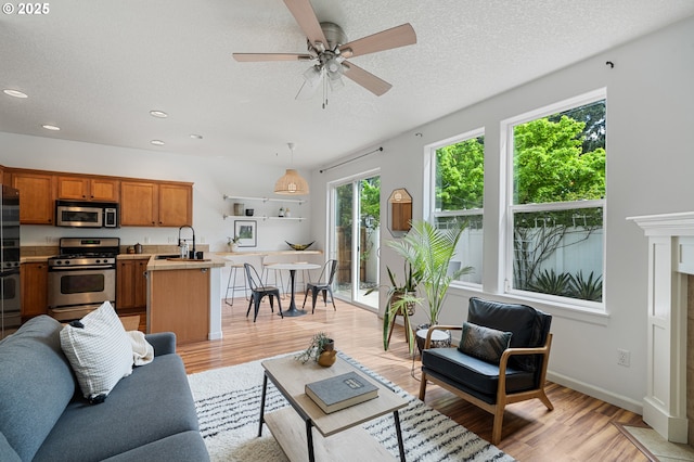 12115 NE 40th Cir, Vancouver, WA 98682 - living area with recessed lighting, light wood-style floors, a textured ceiling, and a ceiling fan