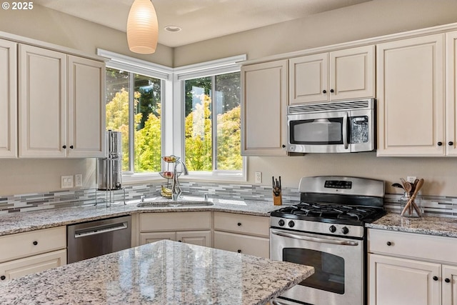 2814 NW Hill St, Camas, WA 98607 - kitchen with stainless steel appliances, healthy amount of natural light, light stone counters, and white cabinetry