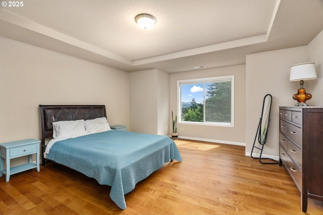 2814 NW Hill St, Camas, WA 98607 - bedroom with light wood-style floors and a raised ceiling