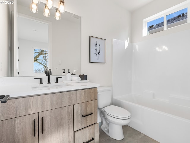 full bathroom featuring vanity, bathtub / shower combination, a wealth of natural light, and toilet