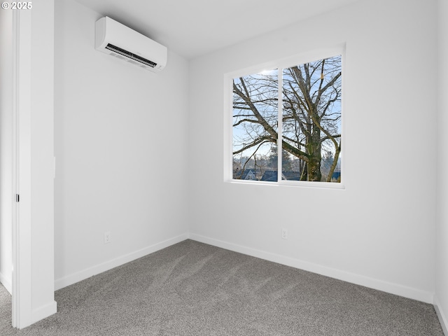 carpeted spare room featuring an AC wall unit