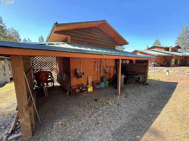 view of side of home featuring metal roof and a carport
