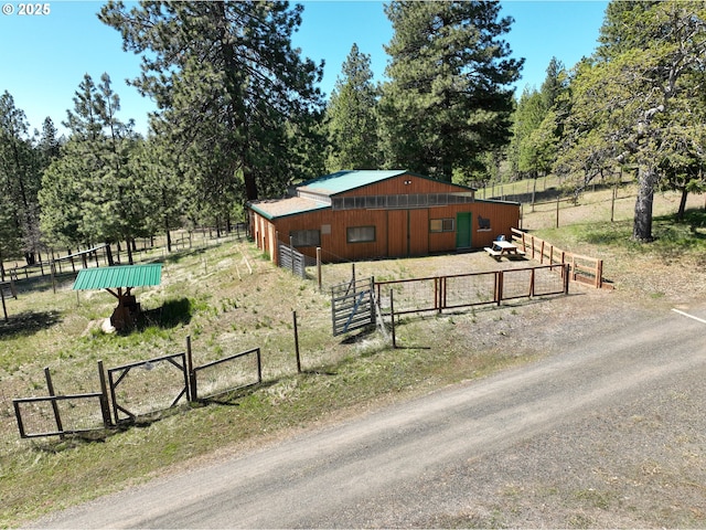 view of stable with a rural view